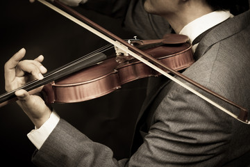 asian male musician playing violin on dark background © princeoflove