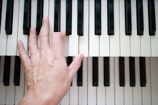 left hand playing lower music keyboard