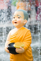 Close up Cute Kid Thai Monk Statues of Buddhist doing Morning Alms Round. © Quality Stock Arts