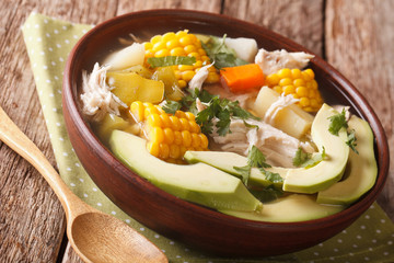 Potato soup ajiaco with chicken close up in a bowl. horizontal
