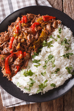 Latin American cuisine: ropa vieja with rice close-up. Vertical top view
