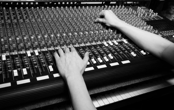 Hands Of Sound Engineer Working On Recording Studio Mixer. Bw Filter