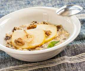 Oatmeal with pear and walnuts in the bowl