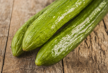 Cucumbers on a wooden background.
