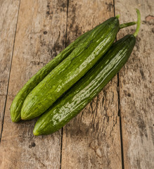 Cucumbers on a wooden background.