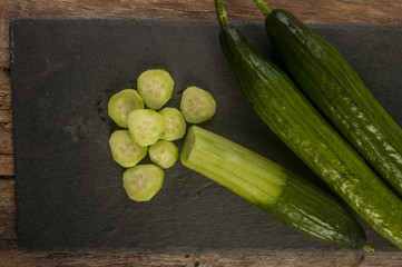 Fresh Cucumber slices on wood background