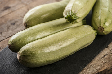 Fresh zucchini on wooden background