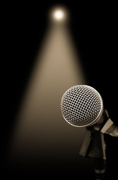 dynamic microphone on stage with spotlight for music background