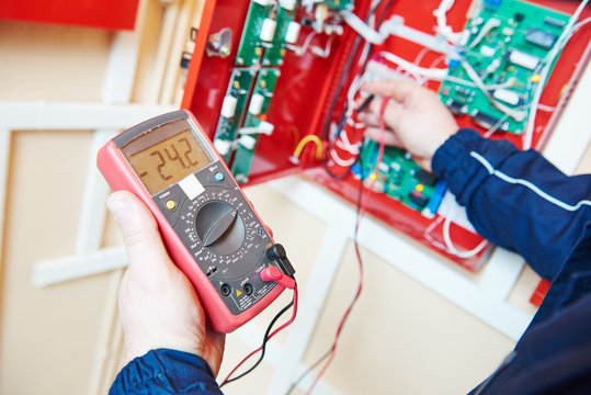 electrician work with multimeter tester