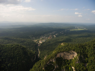 view of a large wooded hill and village Guamka