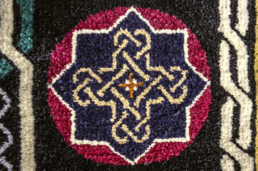 Pattern cross from ethnic symbol of eternity on  border of the carpet
