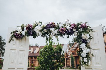 The arch is decorated for the wedding ceremony of the composition of flowers and greenery