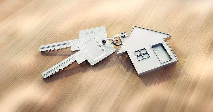 Haus-Schl&uuml;ssel auf hellem Holz im Sonnenlicht