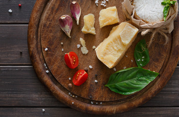 Cheese delikatessen closeup on rustic wood, brie and parmesan