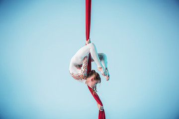Graceful gymnast performing aerial exercise
