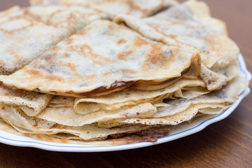 Fried pancakes with chocolate cream served on the plate