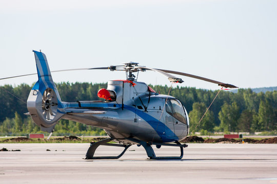 Single engine light helicopter on the airport apron