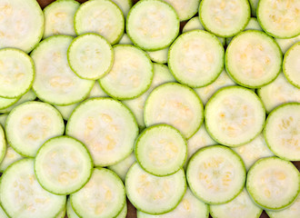Slices ripe fruits of zucchini (texture, background)
