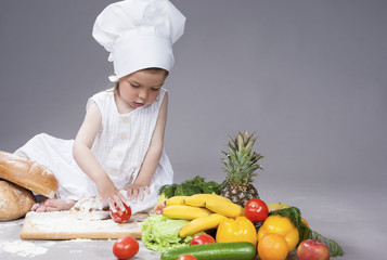 Cooking Concepts. Little Caucasian Girl Posing as Cook with Vegetables