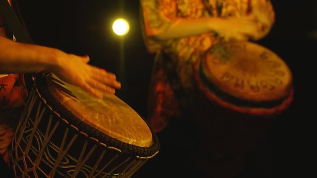 the drummers beat a hand drum