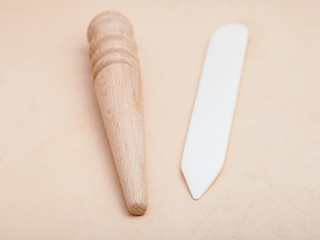 flat and round wood slickers on natural leather