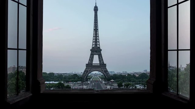 unusual view of the eiffel tower seen from a window time lapse from night to day sunrise,new day birth over paris 4k