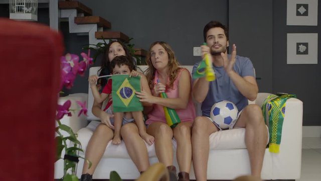 Family of Brazilian soccer fans celebrating
