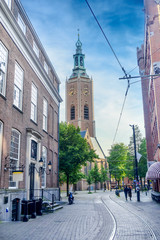 Pretty European city with clock tower near street