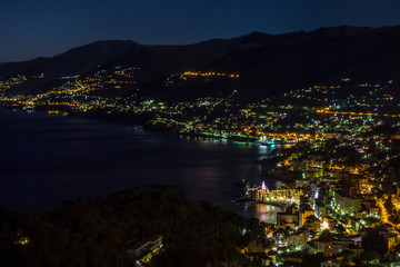 Camogli, Italy, beautiful old mediterranean town at night with illuminations, view from the mountain