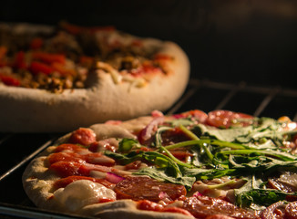 Chef prepares pepperoni pizza in the oven, view from the inside of the . Cooking in the .