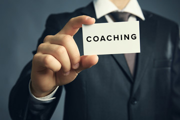 Business trainer with business card, close-up