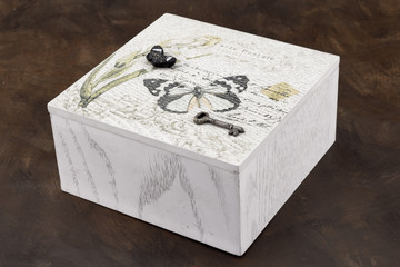 White painted wood box with butterfly and key