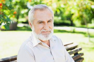 Closeup portrait of a smiling senior man outdoors