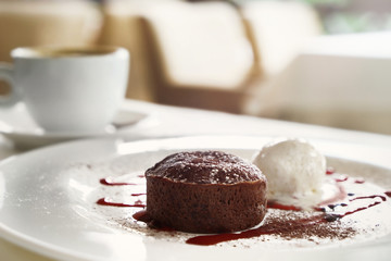 Chocolate cake with cup of coffee on table