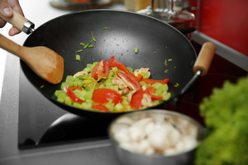 Mixing vegetables in pan closeup