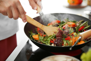 Mixing vegetables in pan closeup