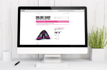 white workspace with online shop on screen