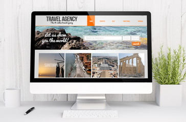 white workspace with computer travel agency website
