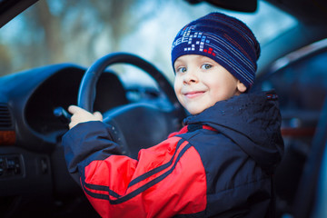 Funny boy car driver with the steering wheel, concept