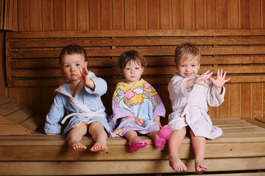 three funny children in sauna