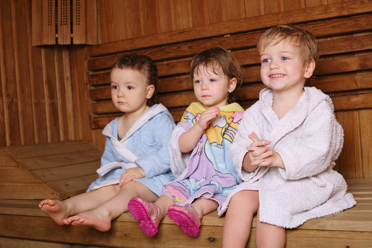 three funny children in sauna