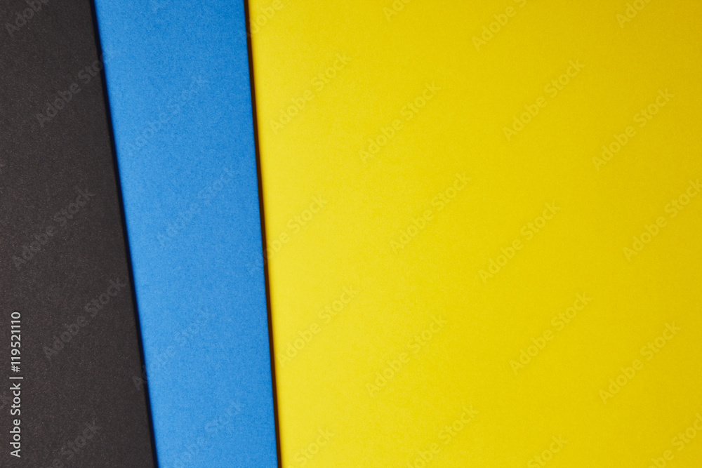 Wall mural colored cardboards background in yellow blue black tone. copy sp