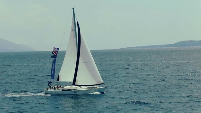 Sailboat floating along the coastline