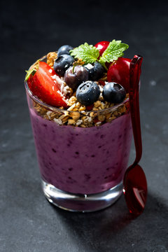 Healthy Dessert With Granola And Berries On A Dark Background