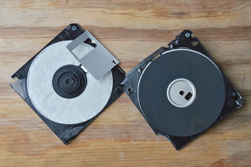 broken diskette disk on wooden board