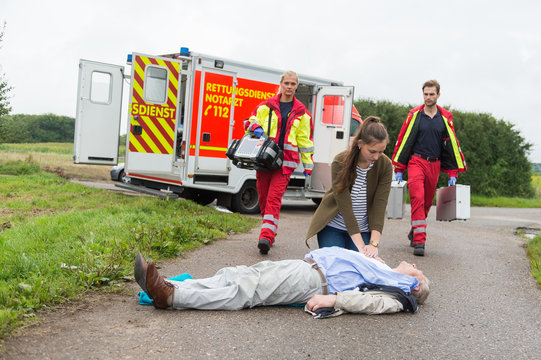 Rettungskr&auml;fte treffen an Einsatzort ein w&auml;hrend Ersthelferin erste Hilfe leistet