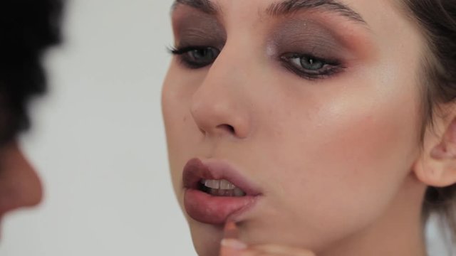 Beautiful young girl makeup lipstick