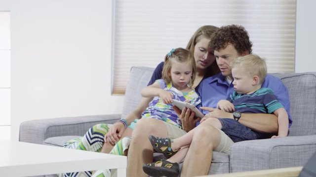 Family using tablet in living room