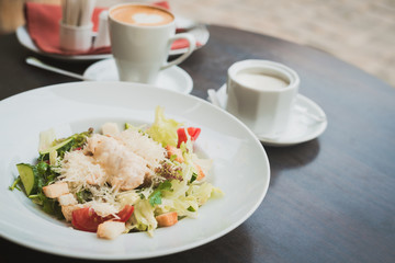 caesar salad and a cup of coffee