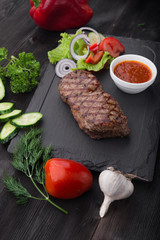 beef steak on with fresh salad on stone